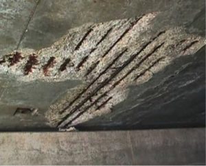 Spalled concrete under bridge without galvanized rebar