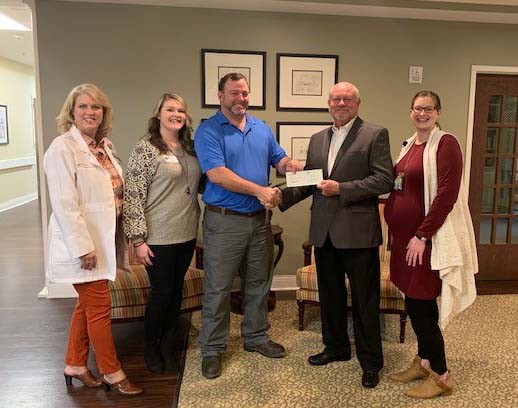 Representatives from The Hospice of Lauren County Receiving a Check From South Atlantic LLC