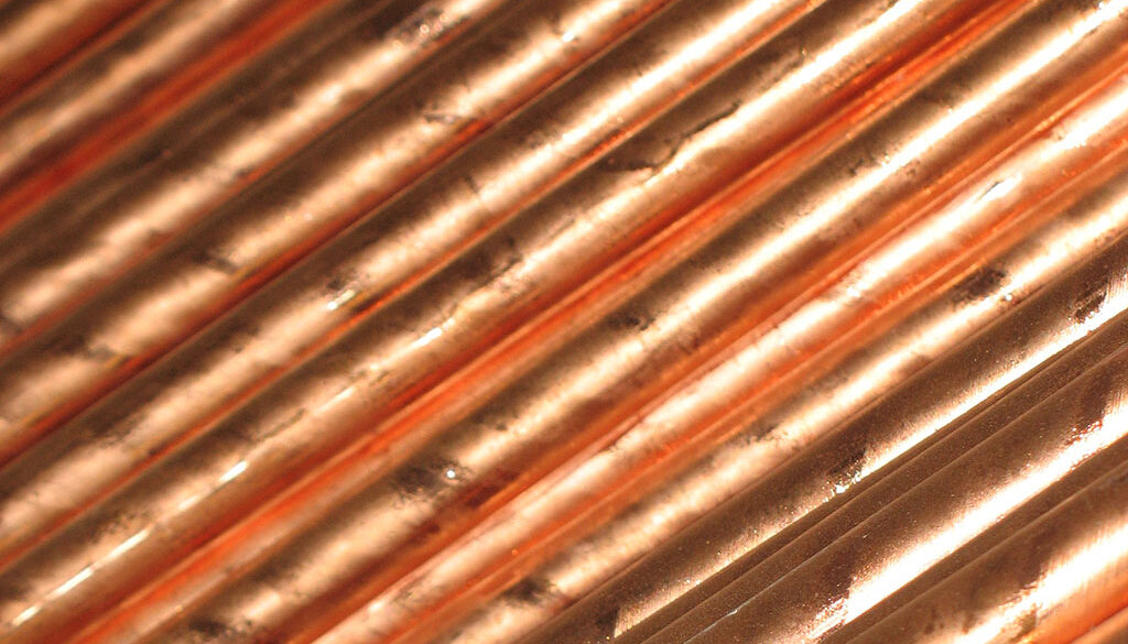 Closeup on a stack of copper colored rods. What is a copper ground rod used for.