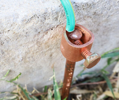 Closeup Of A Copper Grounding Rod Placed Into The Ground Beside A Concrete Slab Ground Rod Durability