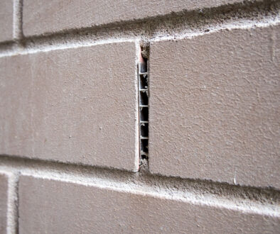 Closeup of a Gray Brick Wall With a Weep Hole What Are Weep Vents