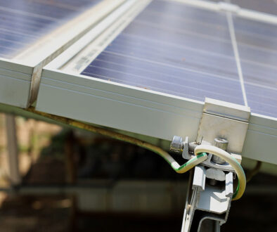 Closeup Of Grounding Wires Mounted To The Side Of Solar Panels Grounding Requirements For Solar Panels