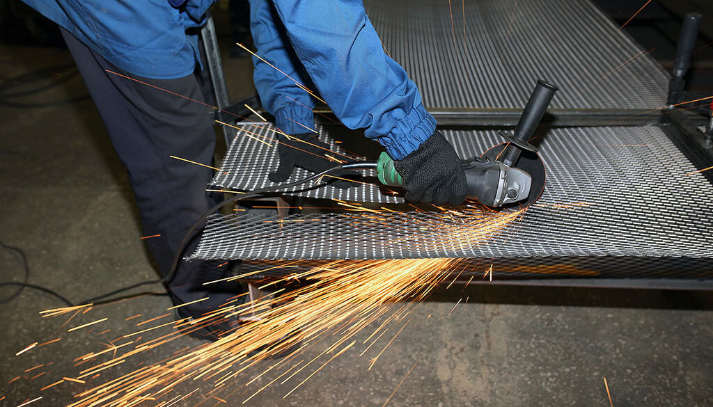 Closeup Of A Person Using A Rotary Tool To Cut Galvanized Wire Mesh Can You Cut Galvanized Wire Mesh