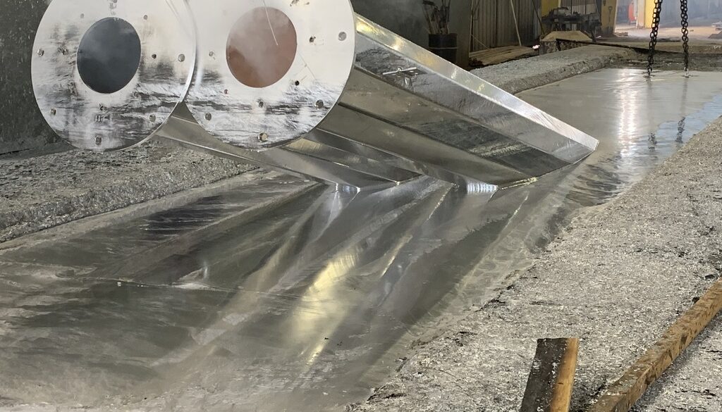 Closeup Of A Steel Beam Being Dipped In A Zinc Bath Hot Dip vs. Electro-galvanizing