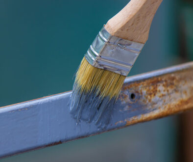 Closeup Of Someone Using A Paint Brush Covered In Zinc Paint To Touch Up Rusted Metal Hot-Dip Galvanizing Vs Zinc Painting