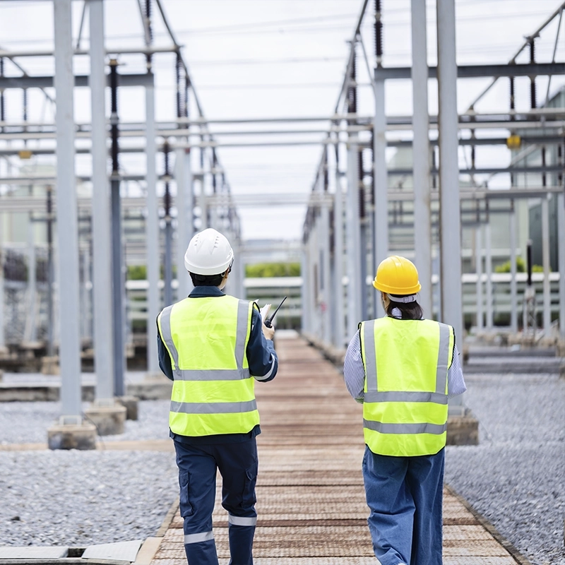 Two engineers wearing hard hats walking together Galvanizing in the utility industry