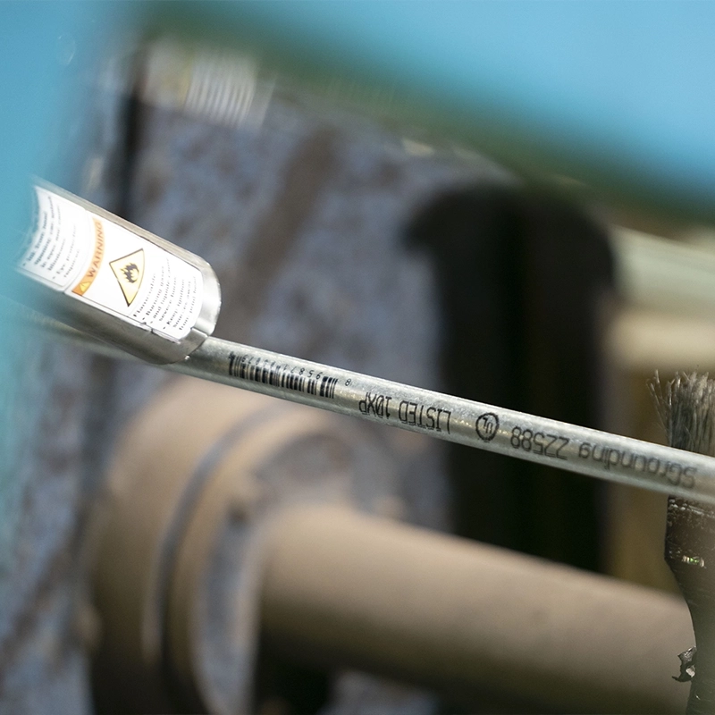 Closeup of a galvanized grounding rod being sprayed