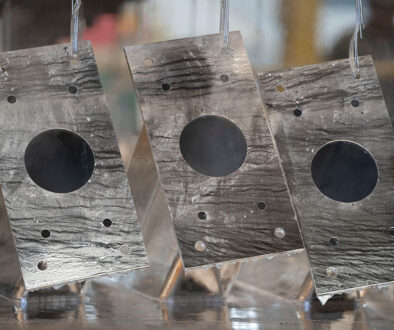 Closeup Of Three Steel Beams Being Lifted Out Of A Zinc Bath PFAS in Galvanized Steel